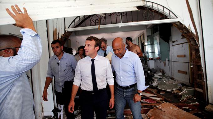 France's President Emmanuel Macron looks on in destroyed building during his visit to the French Caribbean island of St. Martin